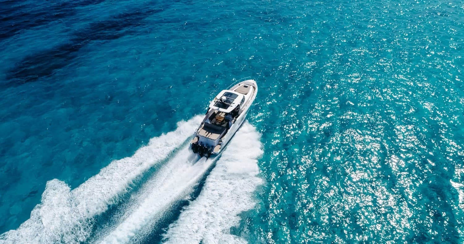 Yacht anchored over turquoise water at Espalmador, Formentera