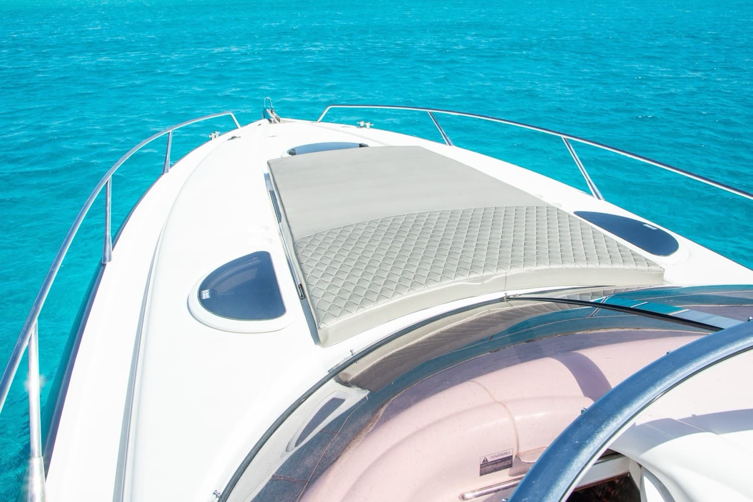 Tender arriving at an exclusive Ibiza beach club at midday